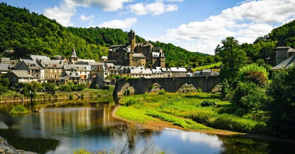 pexels-photo-18530152-18530152 Explore the picturesque village of Estaing and its historic castle surrounded by lush greenery and a serene river.